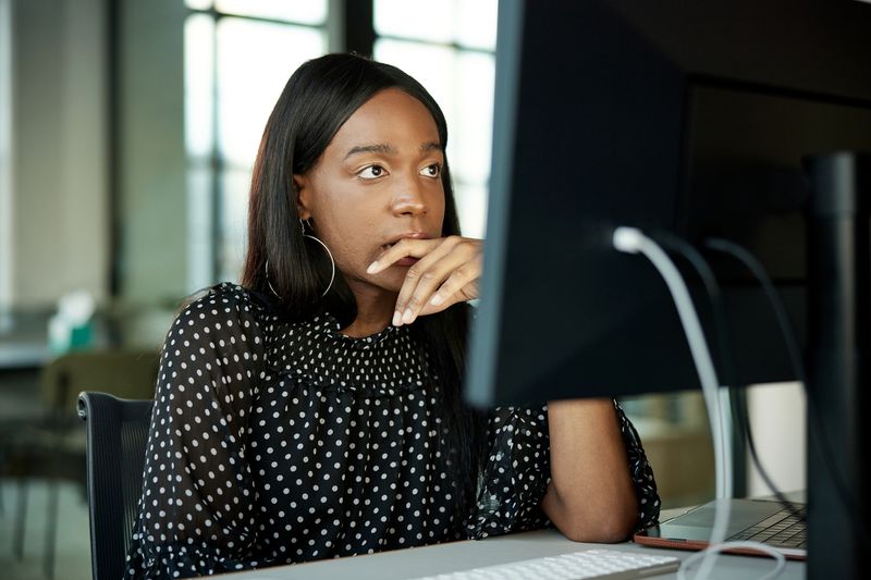 Woman reading about the difference between real estate taxes vs. property taxes