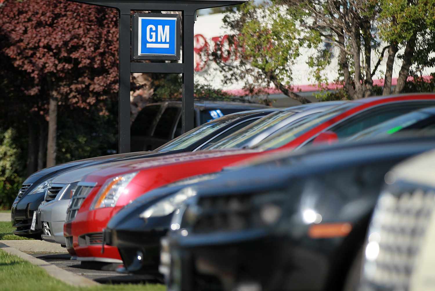 Vehicles sit in a General Motors lot. 