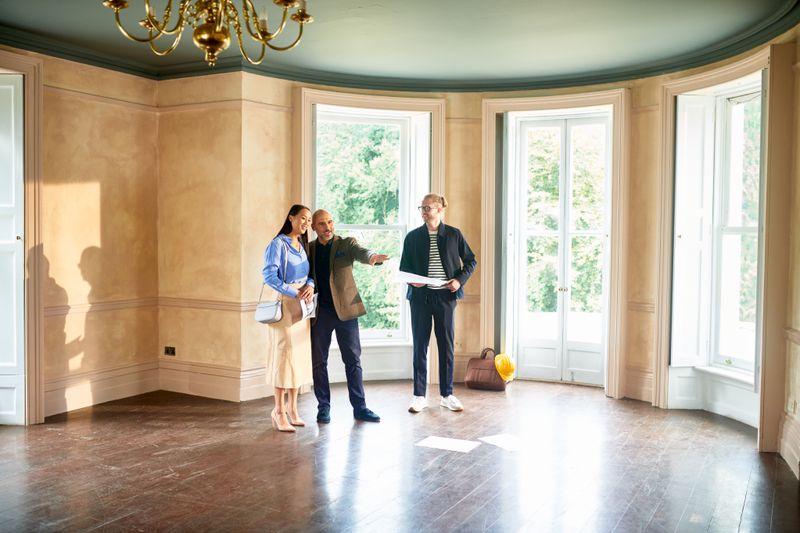 Couple talking with a real estate broker.