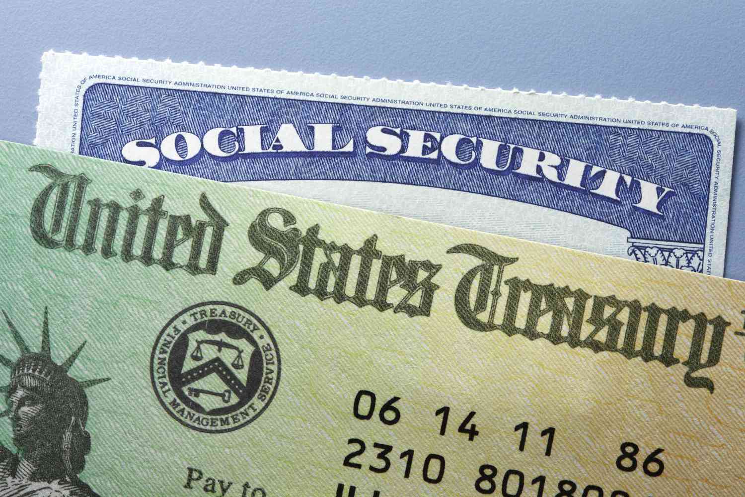 A close up view of a social security card and a United States Treasury check payment.