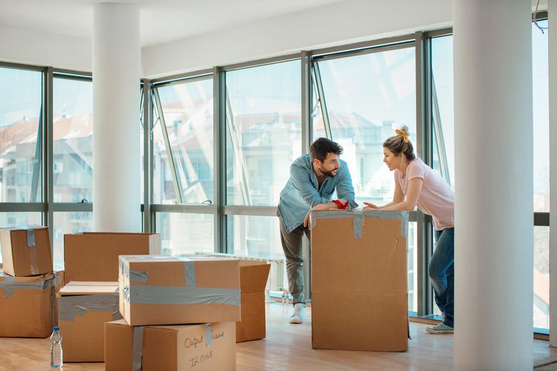 A couple with moving boxes in an apartment