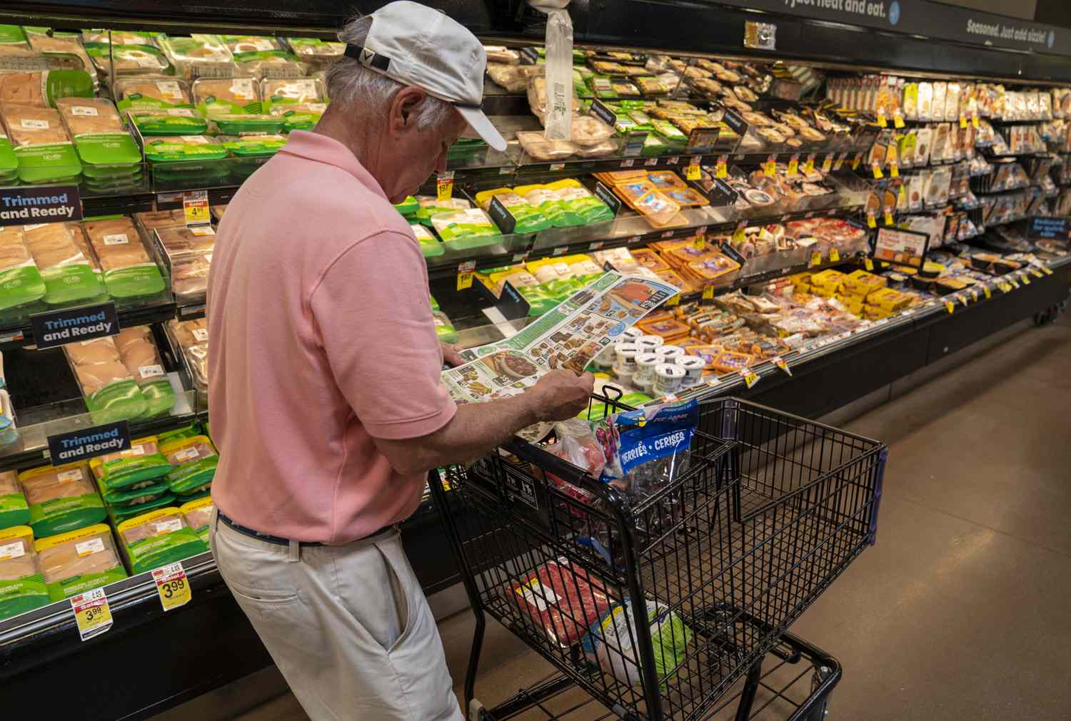A man looks at coupons while shopping at a Shaw's Supermarket July 28, 2023 in Orleans, Massachusetts