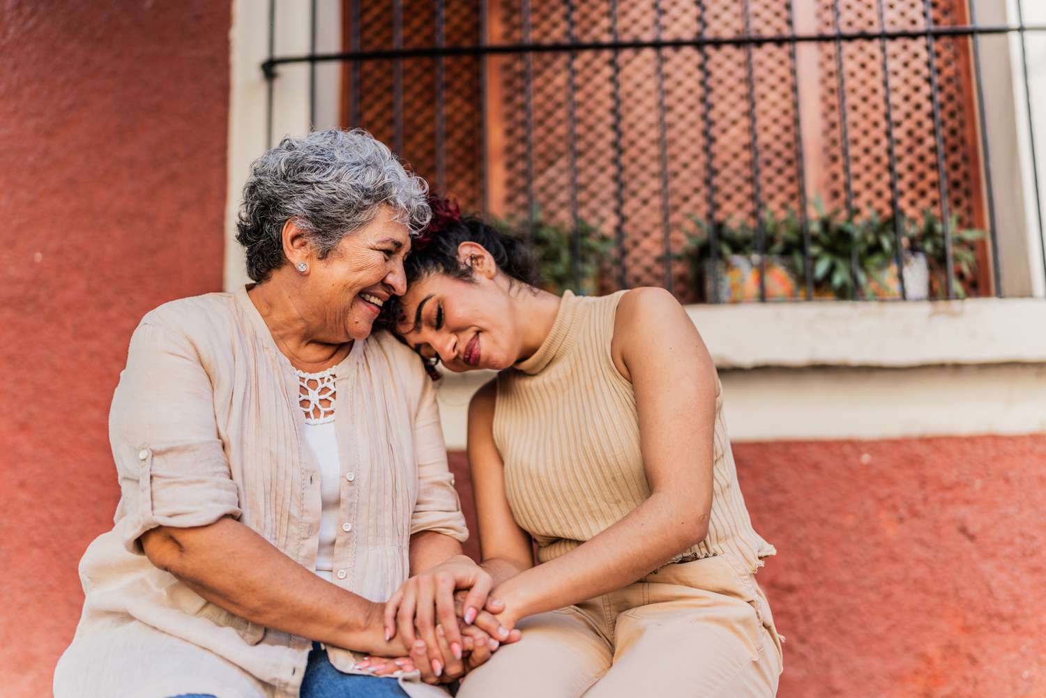 Grandmother and adult granddaughter outside