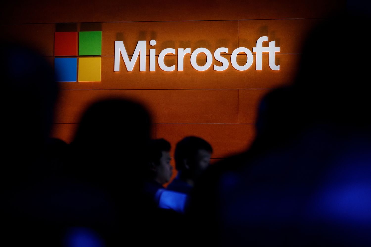 The Microsoft logo is illuminated on a wall during a Microsoft launch event to introduce the new Microsoft Surface laptop and Windows 10 S operating system, May 2, 2017 in New York City.