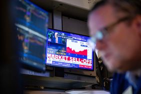 A television displays stock market news on the floor of the New York Stock Exchange.