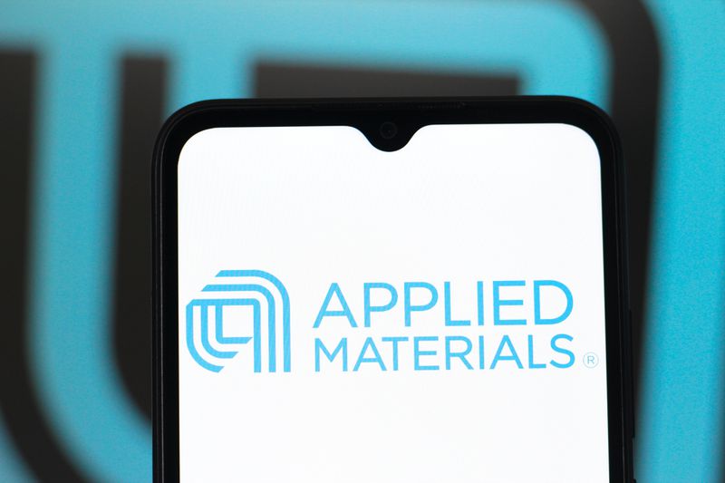 The Applied Materials logo is seen displayed on a smartphone screen