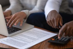 A couple with a computer and a calculator