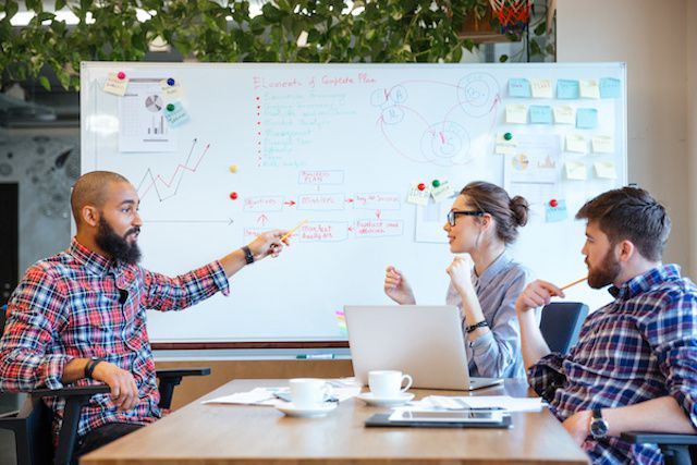 group of people brain storming at table