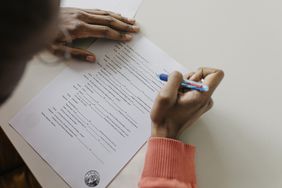 A person holding a pen taking a written exam