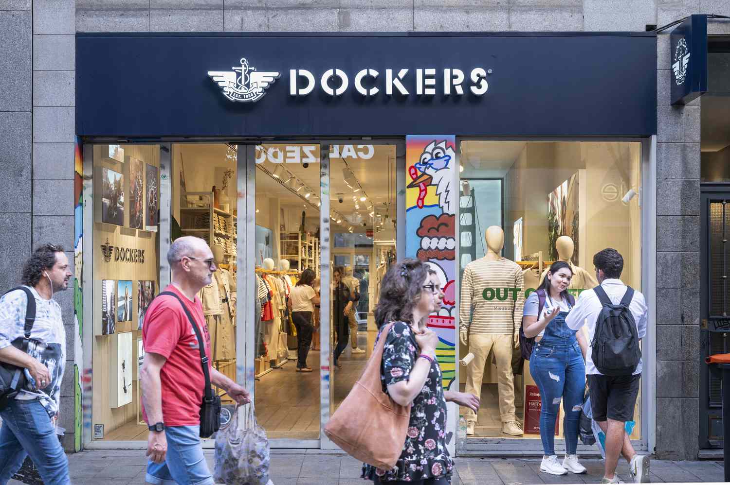 People walk in front of a Dockers storefront.