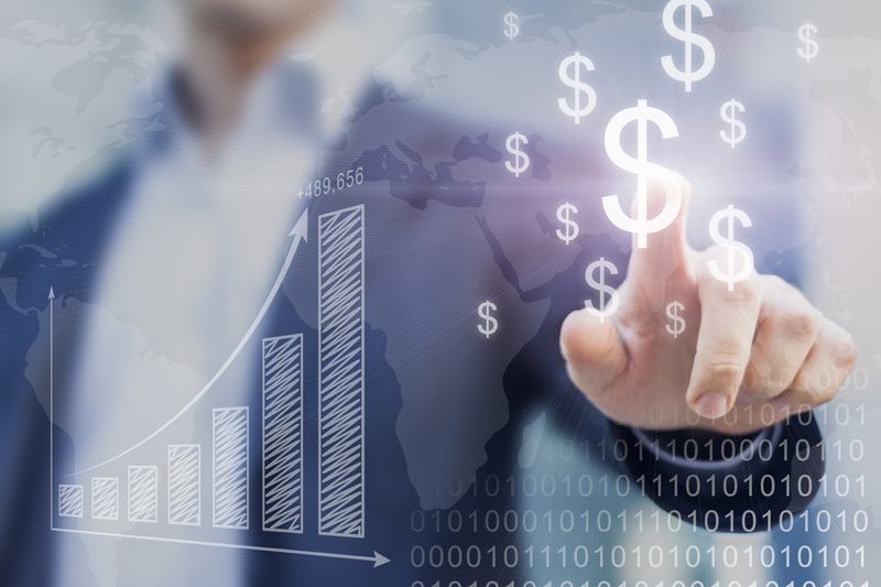 A hand touching a dollar sign among graphics