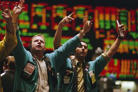 Traders signaling trades on a stock exchange floor