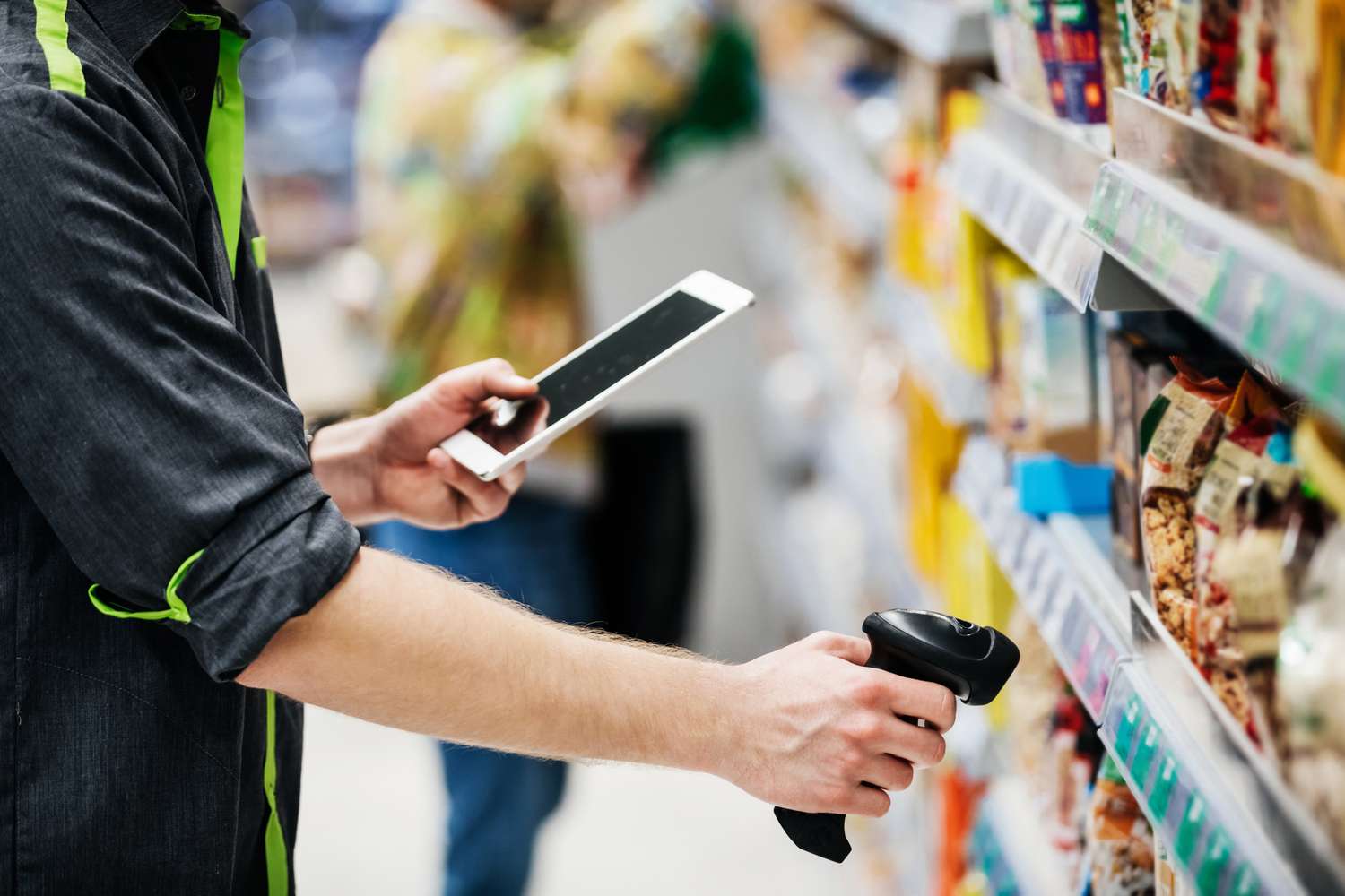 An employee scanning inventory at a grocery store.
