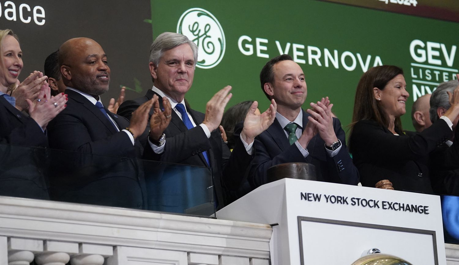CEO of GE Vernova Scott Strazik (2nd R) ring the opening bell at the New York Stock Exchange (NYSE) April 2, 2024, in New York City