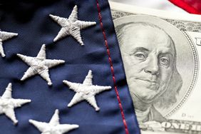 Close-up of U.S. flag and $100 U.S. bill