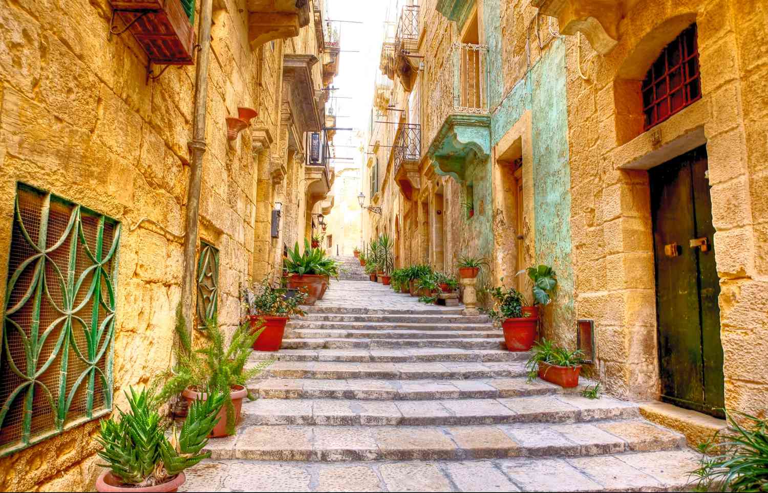 Typical narrow street with stairs in the city Valetta on the island of Malta.