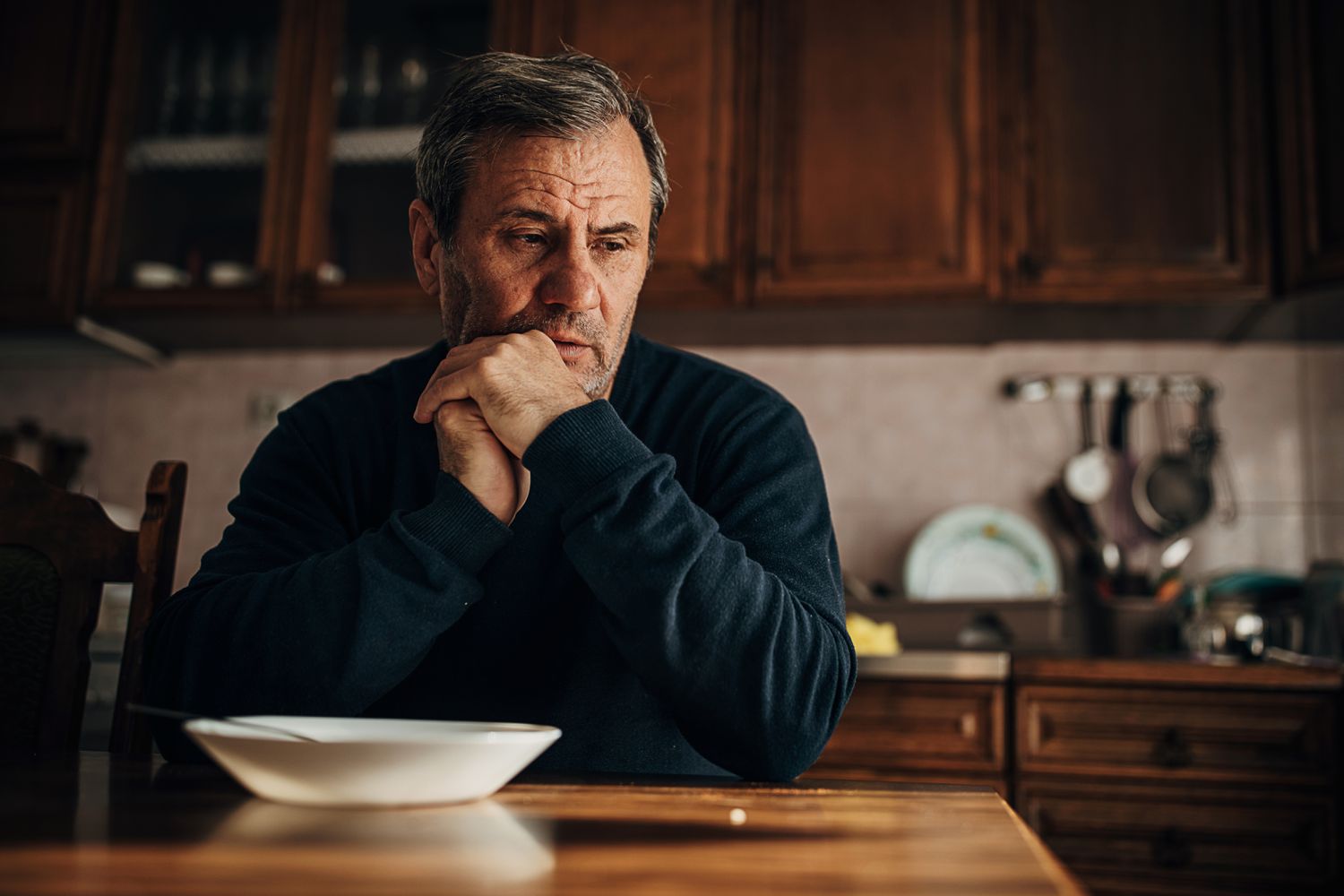 An upset man in a kitchen