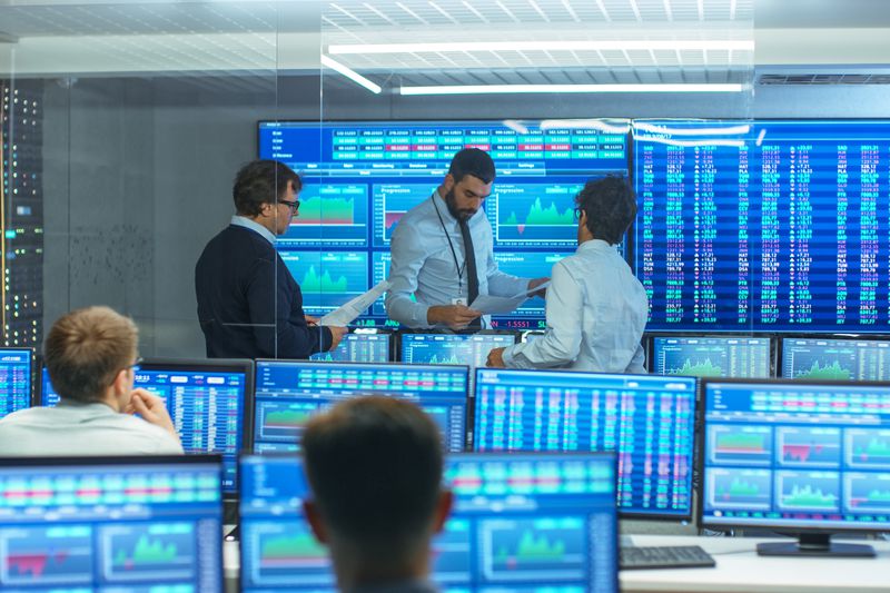 A group of traders examining information
