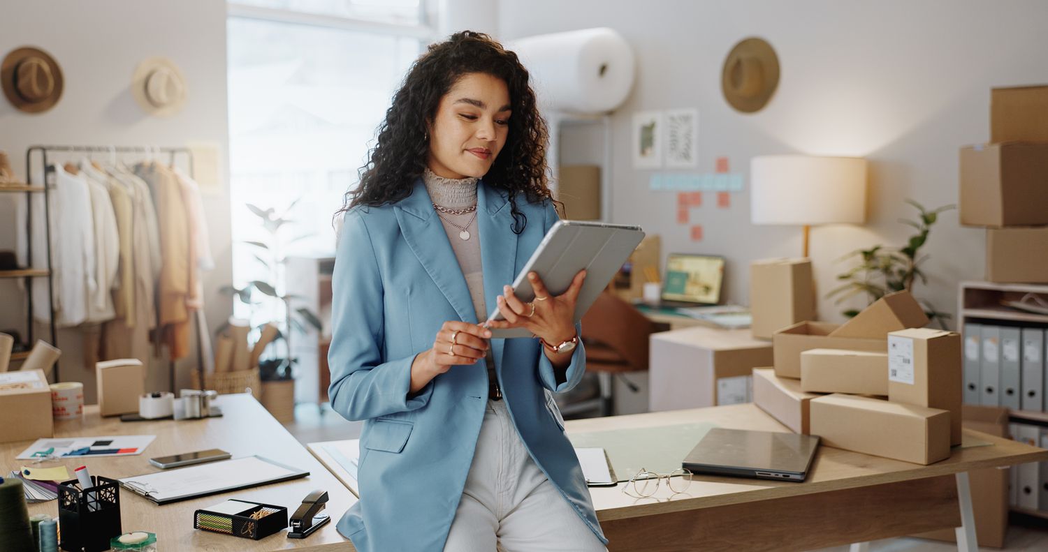 Female person or entrepreneur working on technology in storage or inventory check at retail store or shop