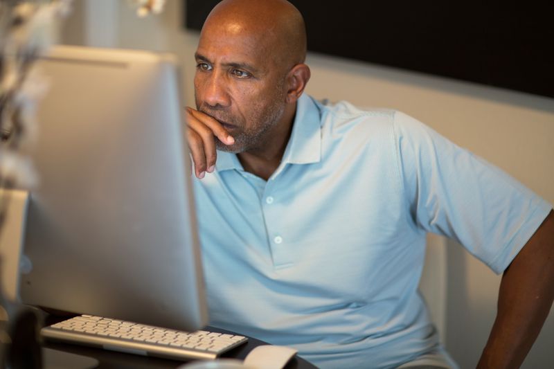 Man research the benefits and drawbacks of both traditional and Roth IRAs