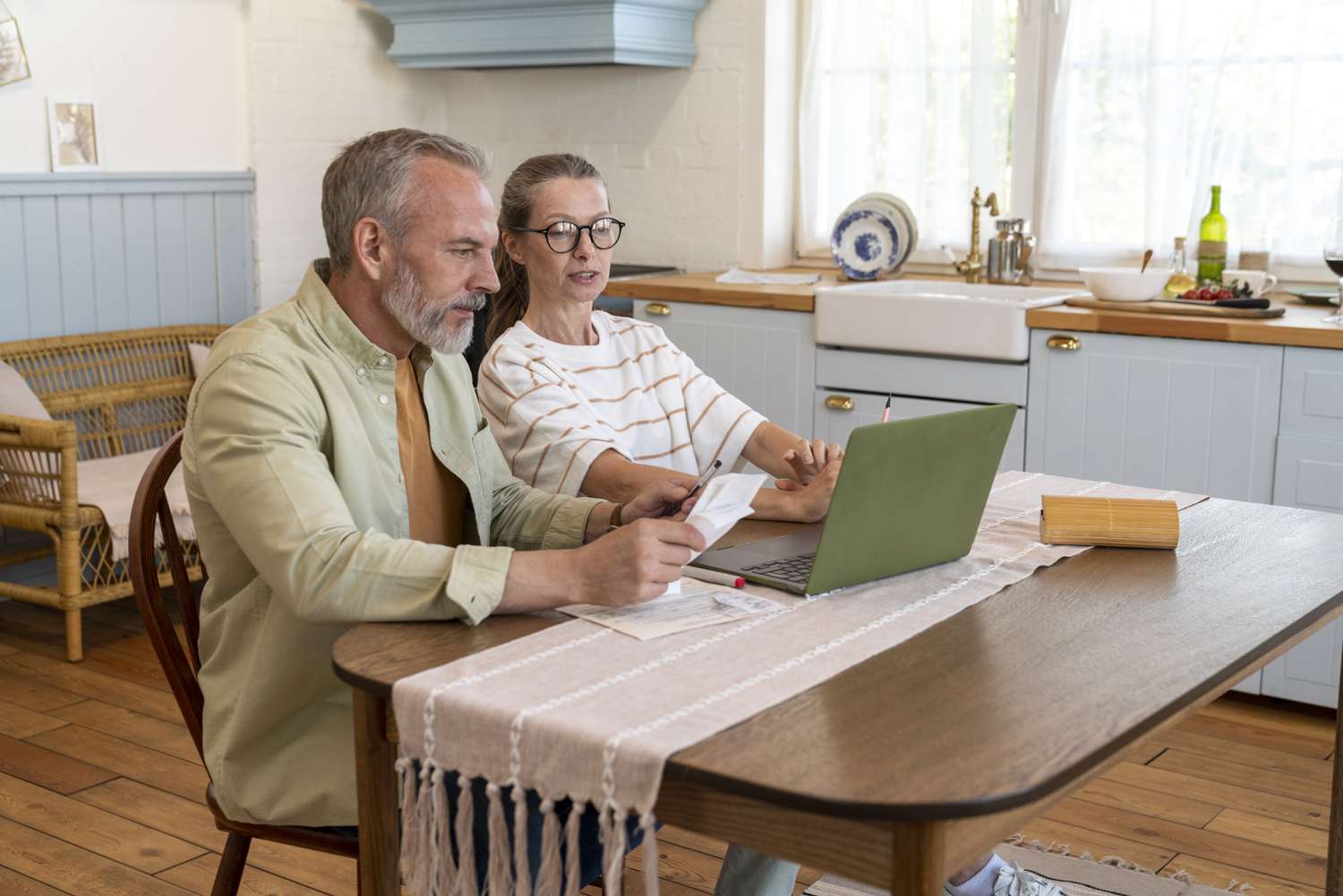 Mid 50s couple discussing getting a mortgage for a bigger home.