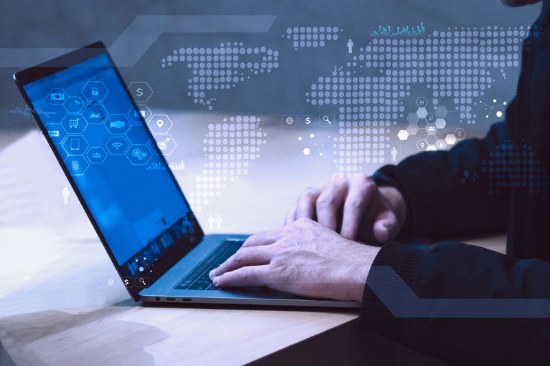 Business person working on computer against technology background.