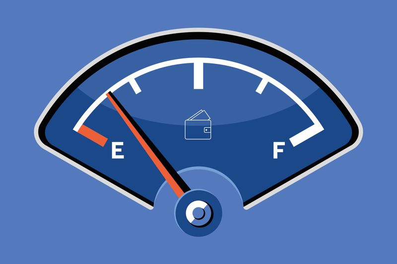 A fuel gauge illustration showing empty with a wallet icon in the center, indicating low on income.