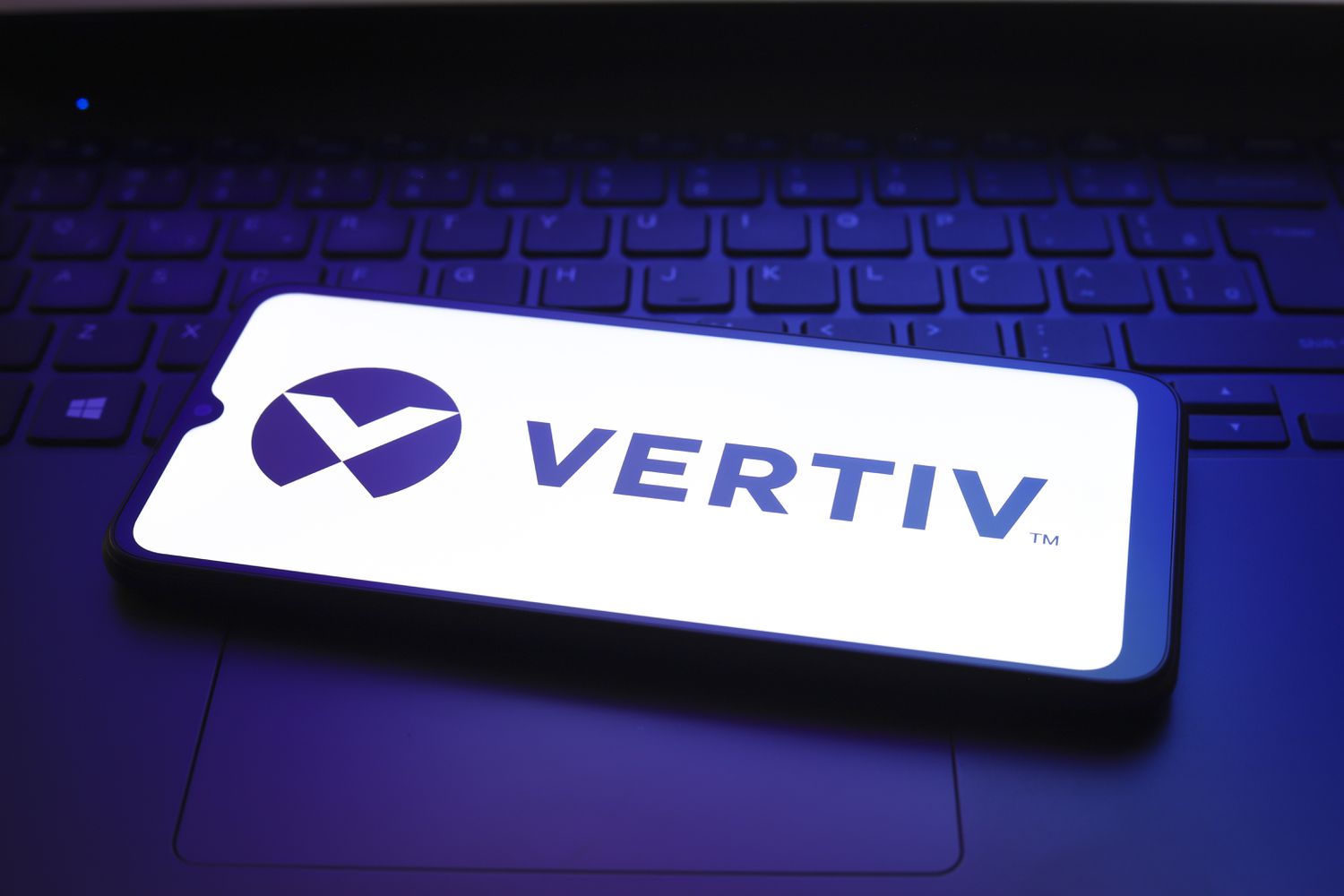 Vertiv Holdings logo appears on a smartphone screen