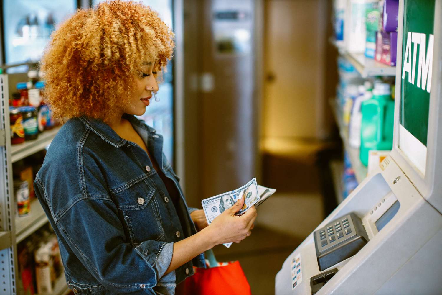 A woman withdrawing cash from an ATM