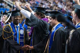 Carl King, Jr. and Huumaay Banegas and their UCLA classmates celebrate their commencement at Pauley Pavilion in Westwood on Friday, June 14, 2024.