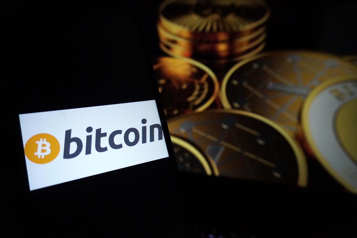a Bitcoin- the world's biggest cryptocurrency, logo seen displayed on a smartphone in New Delhi, India. 