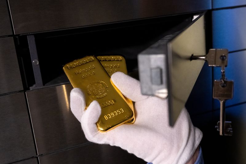 Hand dolding gold bars