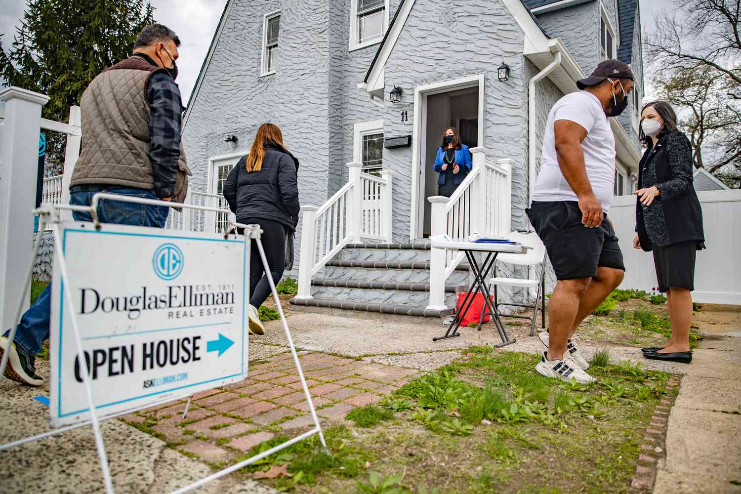 Open house for a home for sale with potential buyers in the foreground.