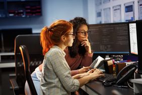 Two female developers figuring out an algorithm