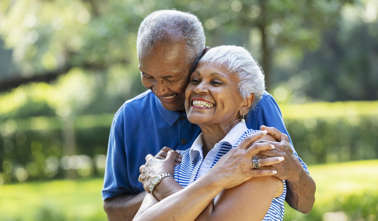 Older couple smiling outside
