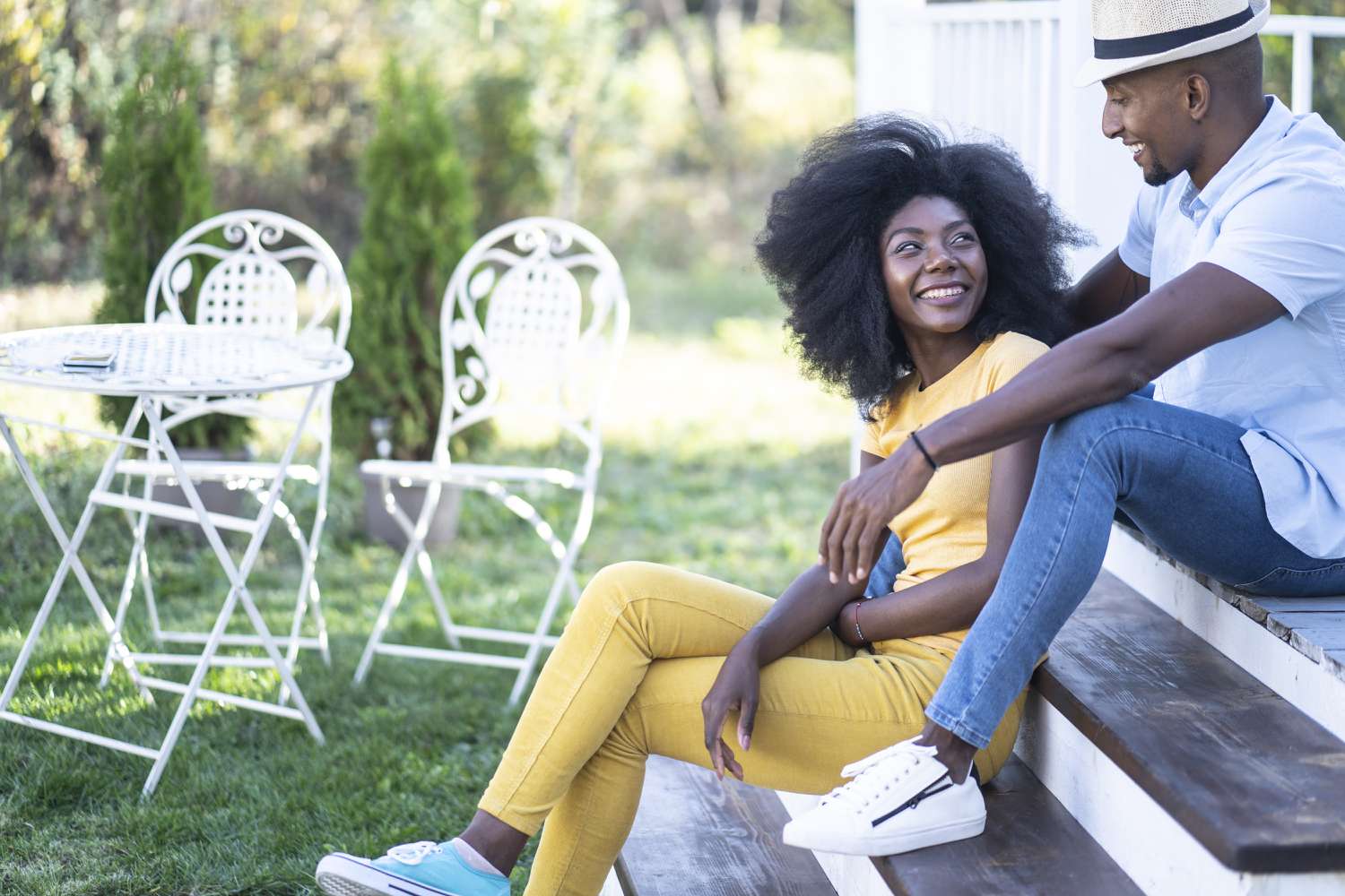 Couple sitting in front of their house.