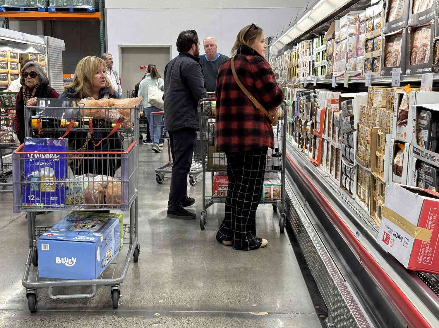 Customers shop for groceries at a Costco store in Novato, California
