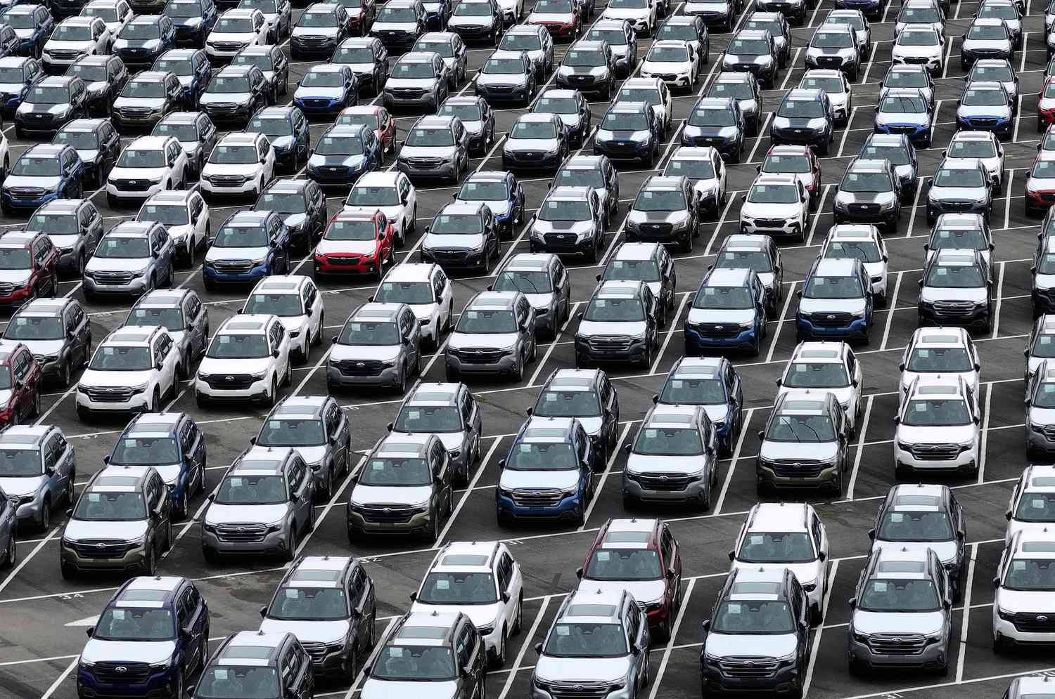 : In an aerial view, brand new Subaru cars sit in a storage lot at Auto Warehouse Co. on March 04, 2025 in Richmond, California. 