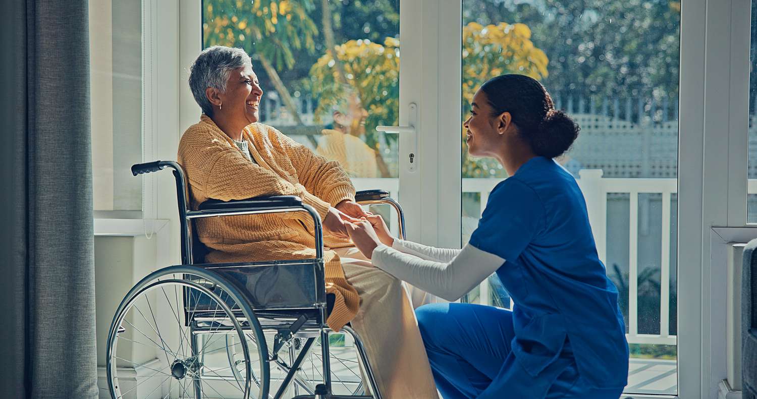 caregiver holds hands of elderly patient