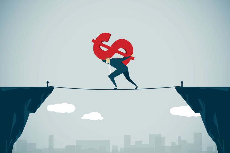 A man caring an heavy dollar symbol.