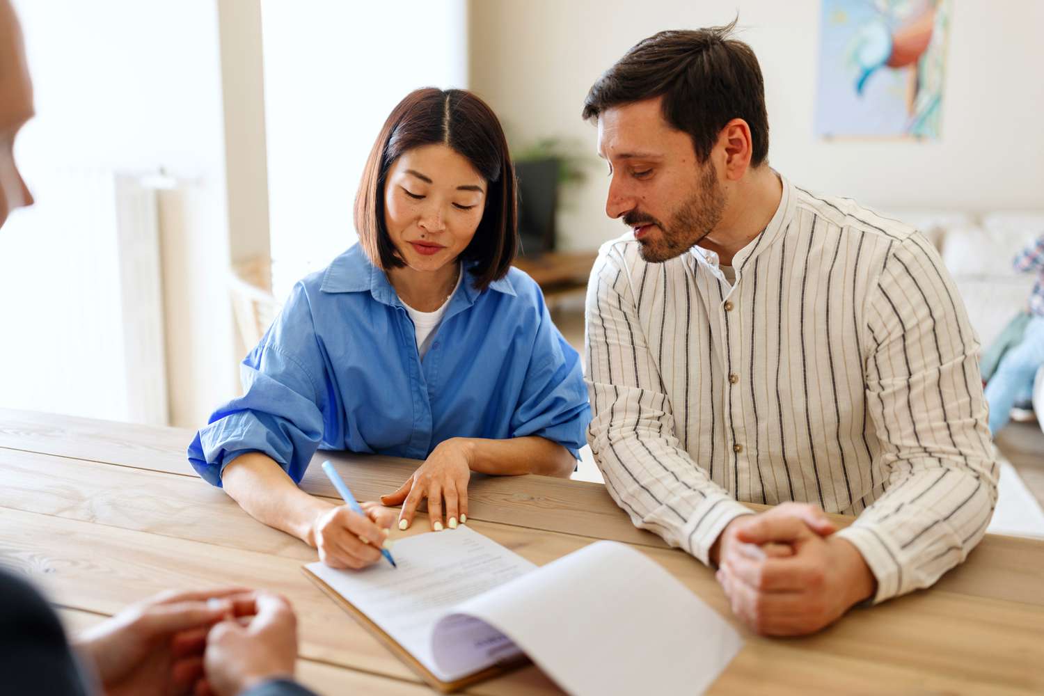 Couple signing mortgage documents