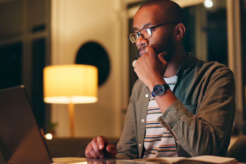 Man working on laptop at night