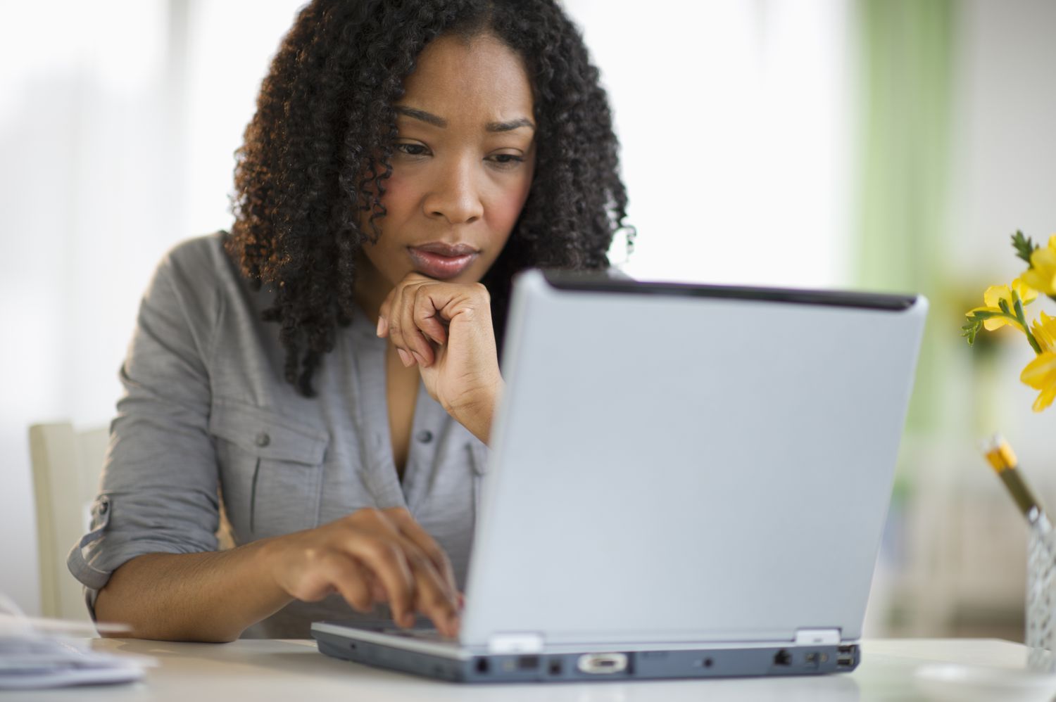 Black woman looking at a laptop computer