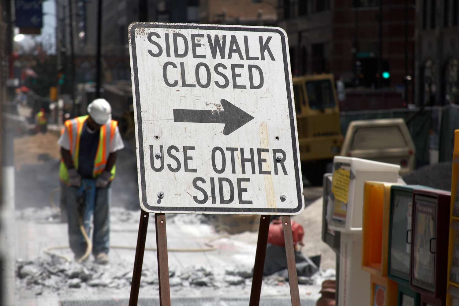Construction crew working on sidewalk funded by special assessment bond.