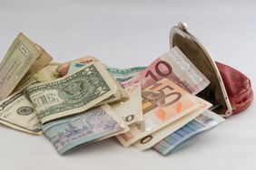 Purse with banknotes of the euro, dollar, ruble and yuan currency.