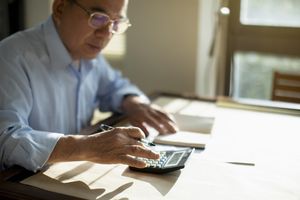 A man uses a calculator.
