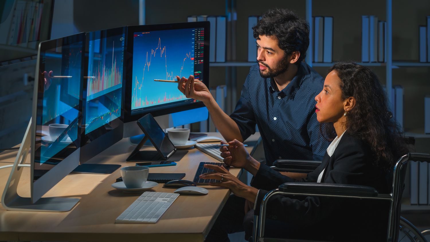 Two traders discussing strategies while analyzing 