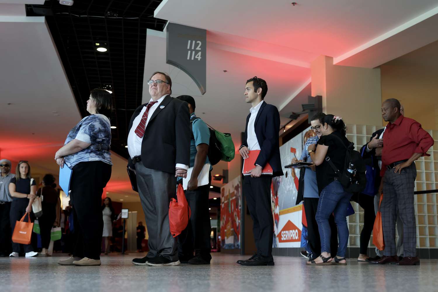 A group of people standing in line within an indoor public space
