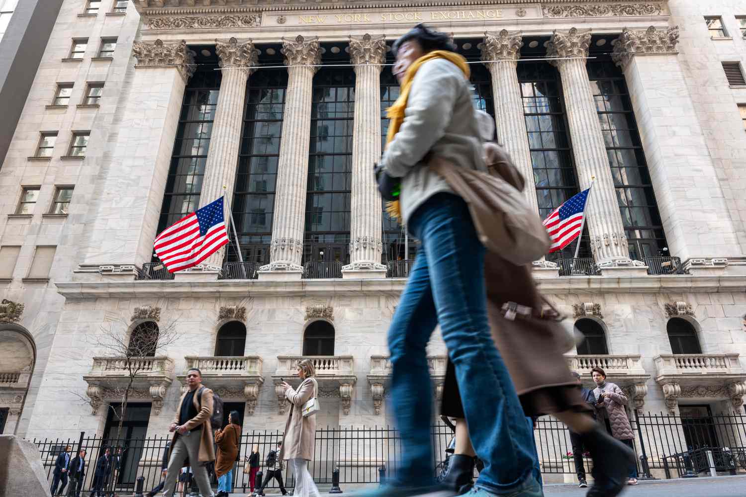 People walk past the New York Stock Exchange.