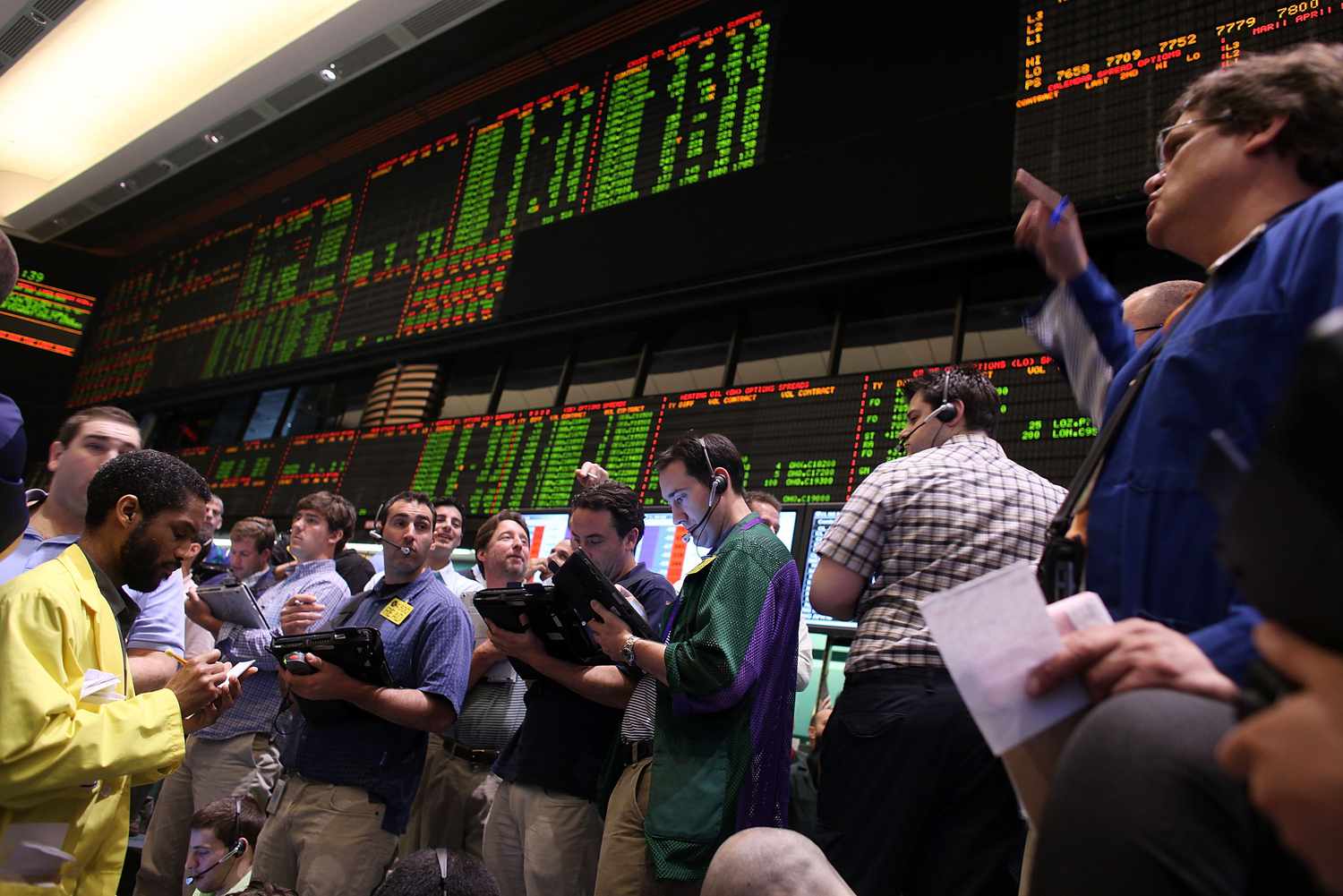 A group of crude oil traders enter orders on the New York Mercantile Exchange floor.